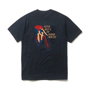 Navy t-shirt on a white background. Cartoon person riding a red & blue bike wearing Red Helmet, red shirt & blue shorts. To the right of the person is the text "Aaron West & The Roaring Twenties"