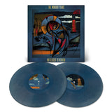 Two blue vinyl records are shown in front of The Wonder Years' No Closer To Heaven 10th Anniversary Edition album cover, which features abstract, colorful artwork with geometric shapes and a stylized face.