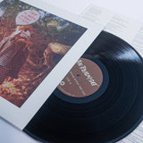 A vinyl record by The Ready Set, titled "I Will Be Nothing Without Your Love," is partially pulled from its sleeve, displaying the label and album art with a wolf-masked person, highlighting the track "Disappearing Act.