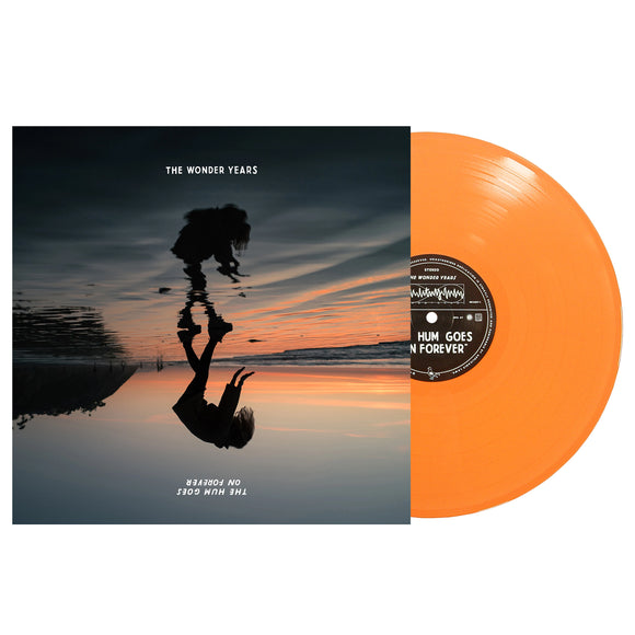 An orange vinyl record by The Wonder Years partially slides from an album cover featuring a sunset, a silhouette with their reflection on water, and the text 