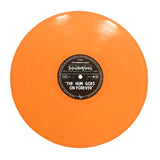 An orange vinyl album by The Wonder Years with a black center label that reads THE HUM GOES ON FOREVER, featuring bold sound wave graphics.