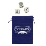 A blue velvet pouch branded Tigers Jaw rests beneath three custom dice, each displaying different numbers, neatly arranged above the bag.