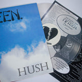A Hush Clear vinyl record by Fifteen includes a lyric sheet and a sleeve with blue sky, clouds, and bold HUSH text. Both the record and lyric sheet feature printed text and a black heart design.