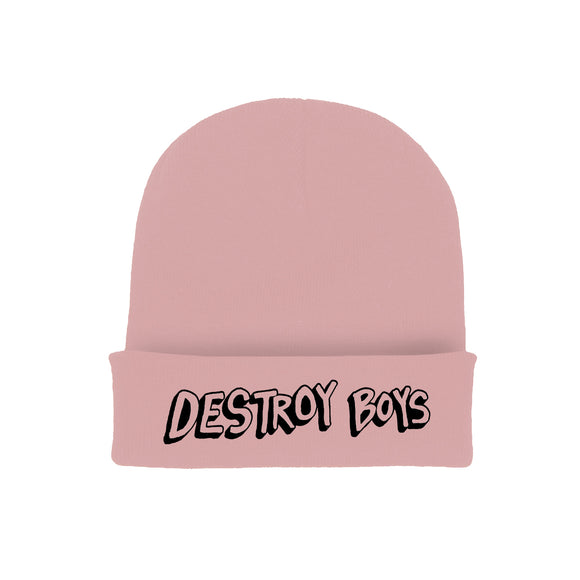 Pink winter cuffed beanie on a white background. Black embroidered text reads 