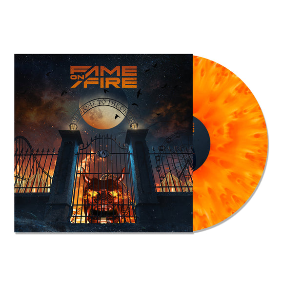image of a vinyl record on a white background. albums cover is on the right and shows an image of a devils face on the bottom, behind a gate to an amusement park in flames. fame on fire is on the top, and the record is shown on the right coming out of the sleeve. the record is orange and dark orange giving a cloudy look.