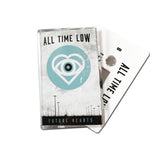 White Cassette on a white background. All Time Low "Future Hearts". Blue circle that contains a heart and eyeball. Shows white cassette