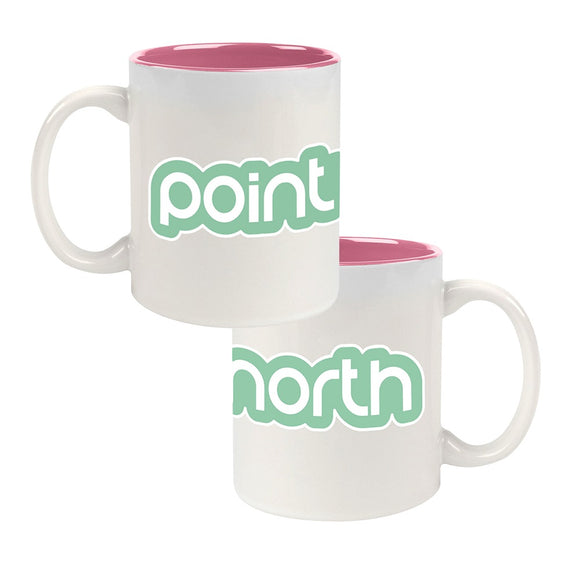 White ceramic coffee mug on a white background. Green & White logo of Point North wraps around the mug. 