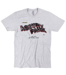 Grey t-shirt on a white background. Text reads "Live From Asbury Park" NJ. The Asbury Park portion is wavy 3D text. Aaron West And The Roaring Twenties in small centered black text below that. 