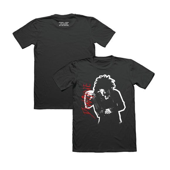 Black t-shirt on a white background. Front has a black & white image of De'wayne on the chest. Red text to the right of the image DE'WAYNE. Back has text on the upper back. Stains / 2021. An Album by De'Wayne. 