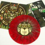 A red splatter vinyl 7 by ROAM with an illustrated Aztec-style face on the label sits before its matching cover and insert, featuring the Head Down 7 tracklist and detailed song info.